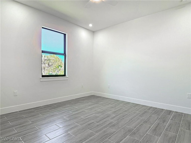 unfurnished room featuring wood tiled floor, ceiling fan, baseboards, and recessed lighting