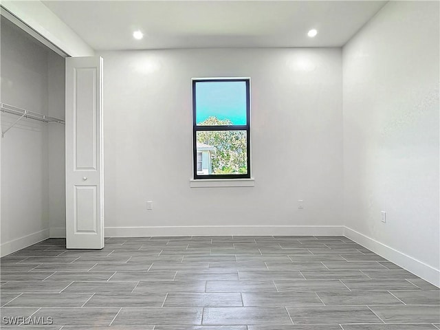 unfurnished bedroom with recessed lighting and baseboards