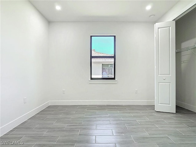 unfurnished bedroom featuring recessed lighting, baseboards, and wood finish floors