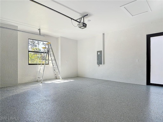 garage with a garage door opener, electric panel, and a textured wall