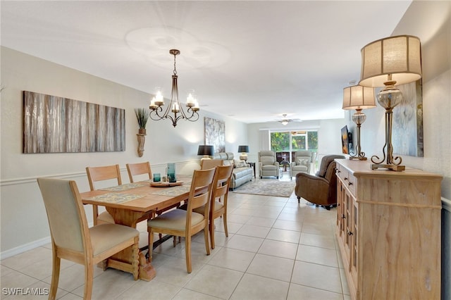 dining room featuring baseboards, light tile patterned floors, and a notable chandelier