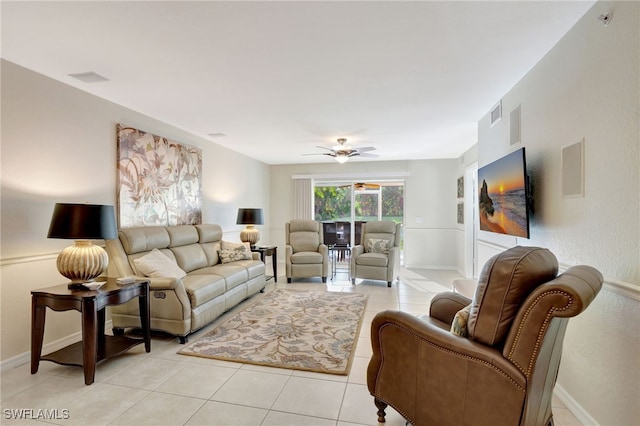 living room featuring visible vents, light tile patterned floors, and a ceiling fan