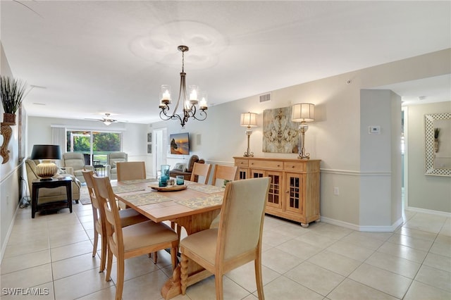 dining area featuring light tile patterned floors, an inviting chandelier, visible vents, and baseboards