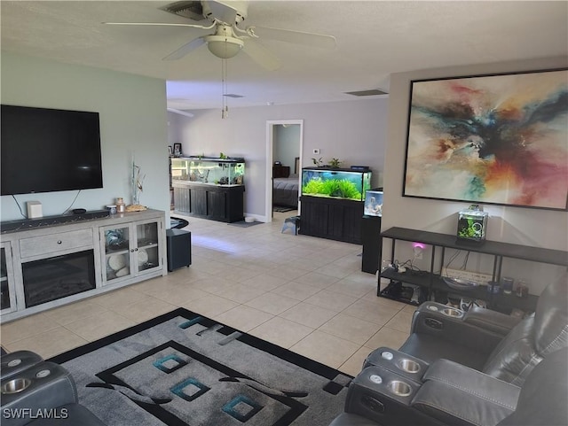 living room featuring visible vents, ceiling fan, and light tile patterned floors