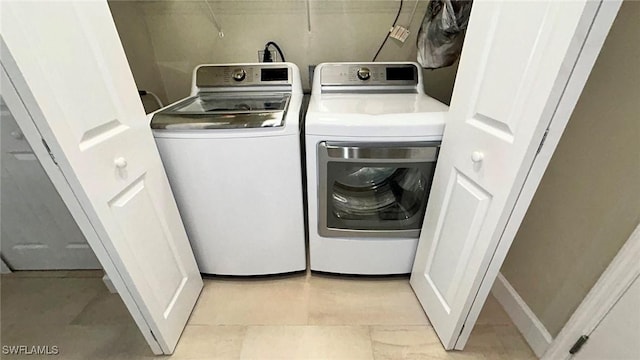 washroom featuring laundry area and washer and dryer