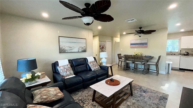 living area featuring ceiling fan, visible vents, baseboards, and recessed lighting