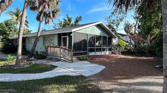 back of property with a sunroom