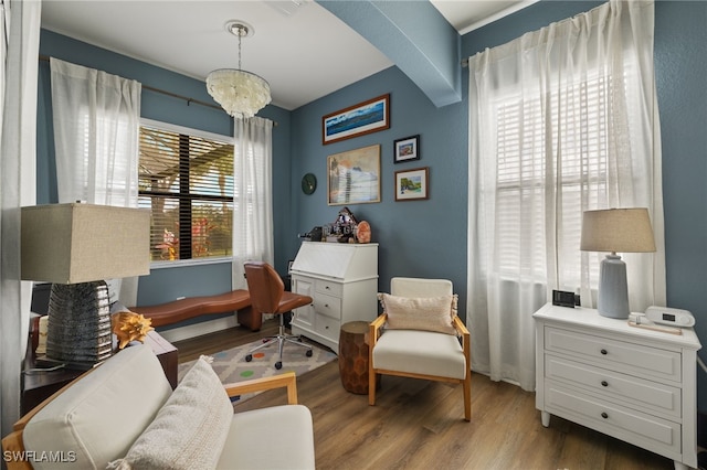 living area with a notable chandelier and wood finished floors