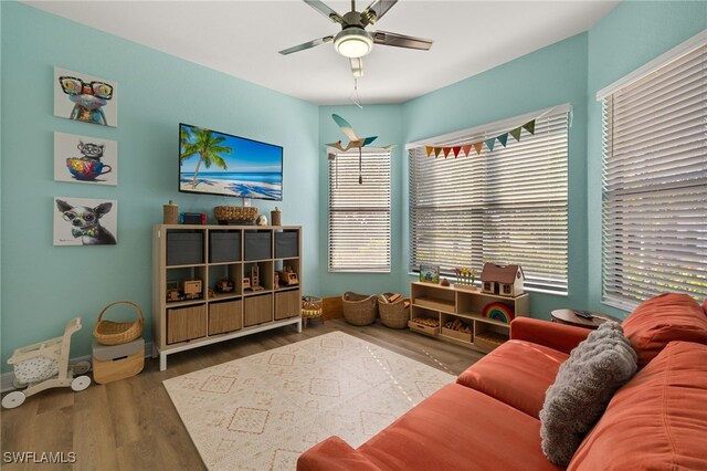 living room with ceiling fan and wood finished floors