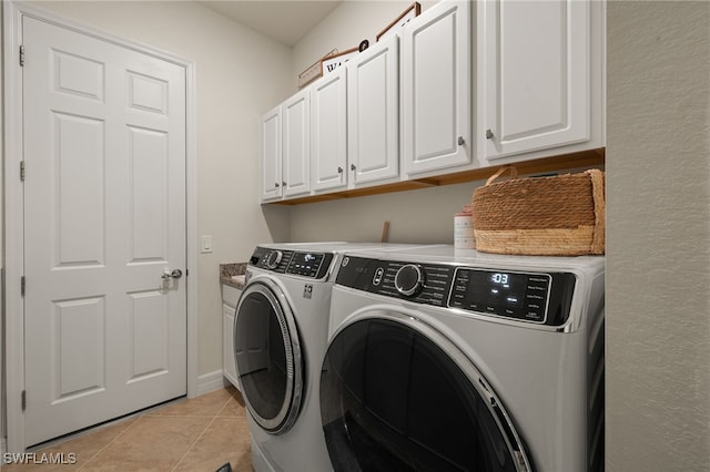 laundry room with cabinet space, independent washer and dryer, and light tile patterned flooring