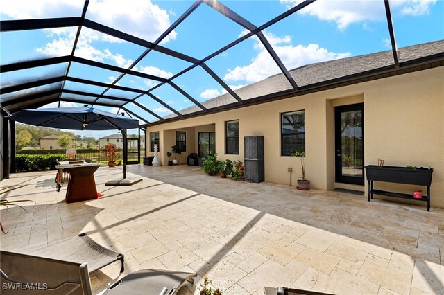 view of patio featuring glass enclosure