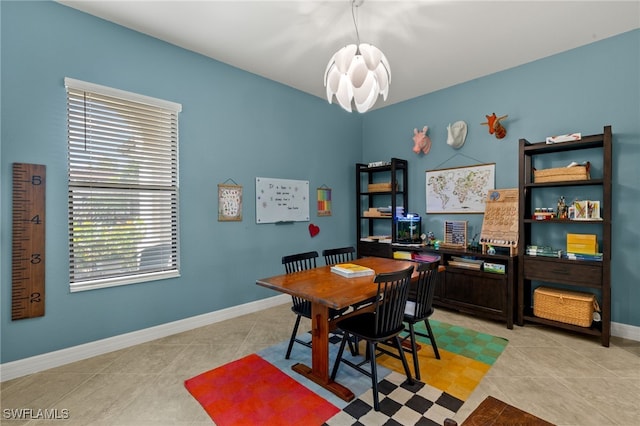 interior space with light tile patterned floors, baseboards, and an inviting chandelier