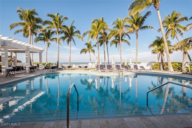 community pool with a patio area and a pergola