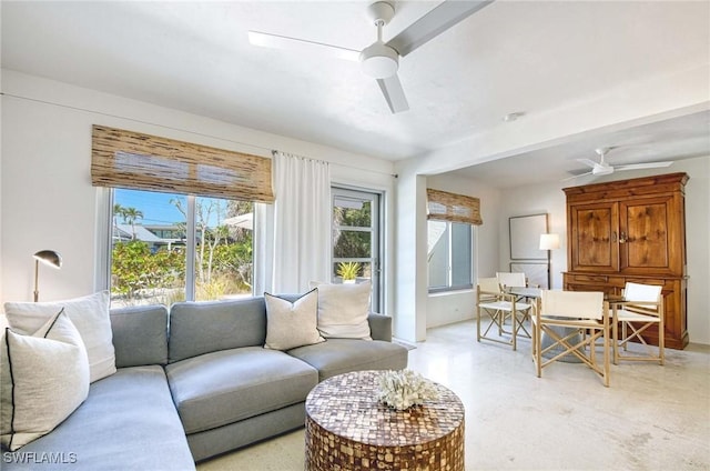 living area featuring a healthy amount of sunlight and ceiling fan