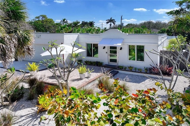 view of front facade featuring a patio and stucco siding