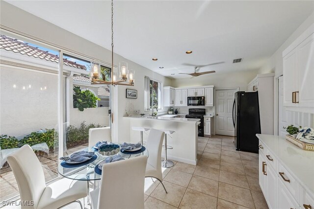 27145 Lost Lake Ln, Bonita Springs, FL 34134 - dining room with an inviting chandelier, light tile patterned floors, recessed lighting, and visible vents