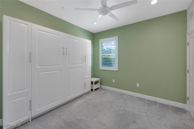 unfurnished bedroom with recessed lighting, light colored carpet, baseboards, and a ceiling fan