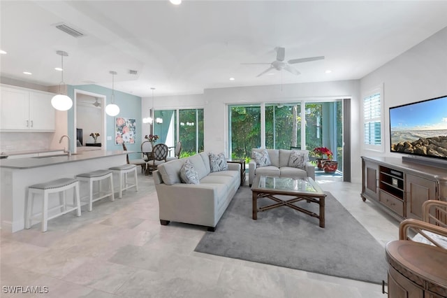 living room with visible vents, a ceiling fan, and recessed lighting