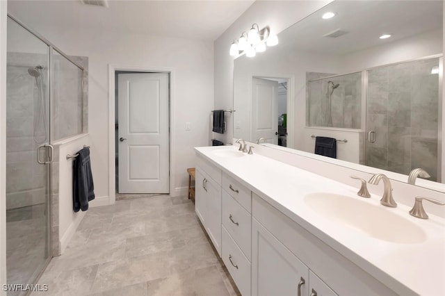bathroom with a sink, visible vents, double vanity, and a stall shower