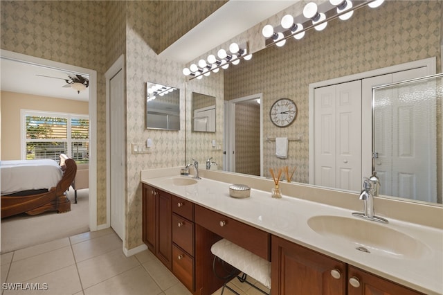 ensuite bathroom with wallpapered walls and a sink