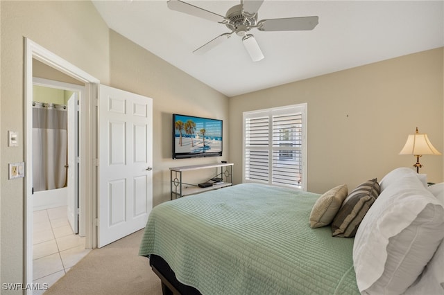 bedroom with light tile patterned floors, light carpet, a ceiling fan, and vaulted ceiling