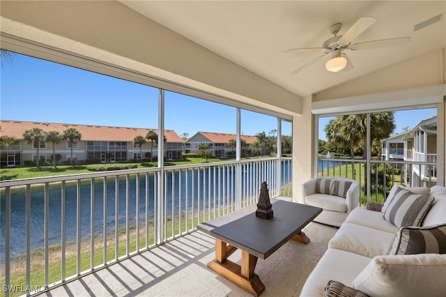 sunroom featuring vaulted ceiling, a water view, and a wealth of natural light