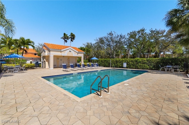 pool with fence and a patio area