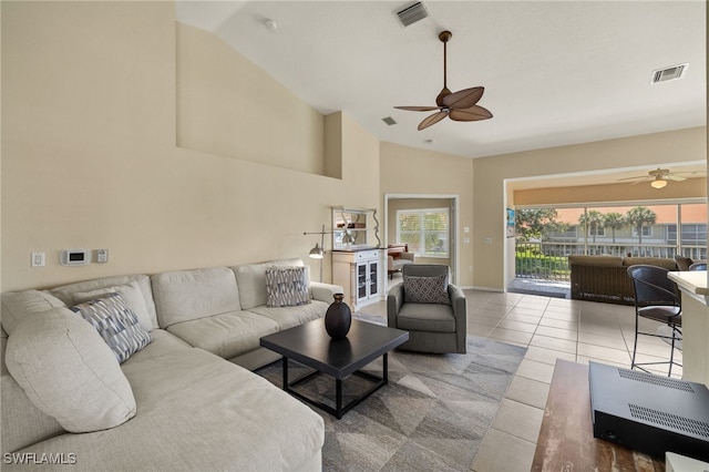 tiled living room featuring visible vents, high vaulted ceiling, and ceiling fan