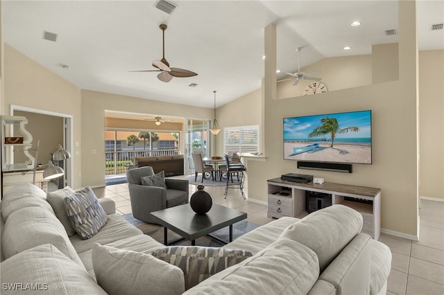 living room featuring light tile patterned floors, visible vents, and baseboards