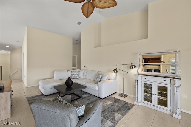 living area with visible vents, high vaulted ceiling, a ceiling fan, tile patterned flooring, and baseboards