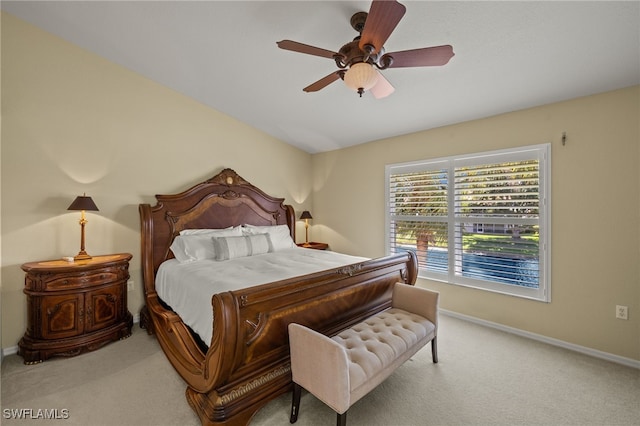 carpeted bedroom with baseboards and ceiling fan