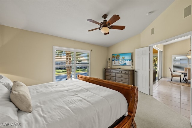 bedroom featuring light tile patterned floors, a ceiling fan, visible vents, lofted ceiling, and light carpet