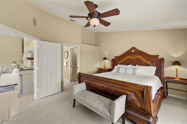 bedroom featuring lofted ceiling, light tile patterned floors, visible vents, and light carpet