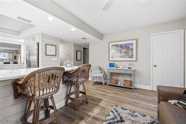 sitting room with light wood-style flooring, recessed lighting, visible vents, a ceiling fan, and baseboards