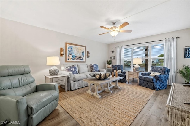 living room with a ceiling fan and wood finished floors