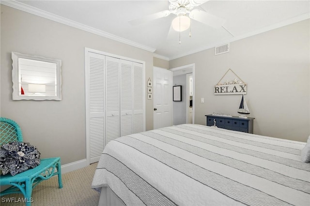 carpeted bedroom with ceiling fan, visible vents, baseboards, a closet, and crown molding