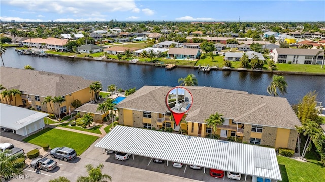 drone / aerial view with a water view and a residential view