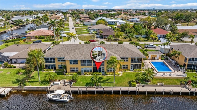 bird's eye view featuring a water view and a residential view