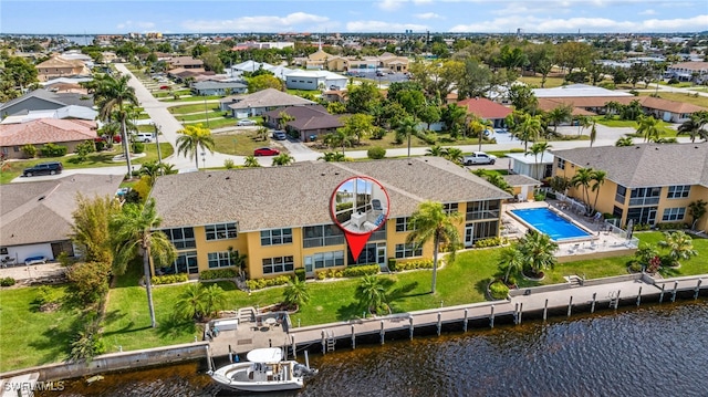 drone / aerial view with a water view and a residential view