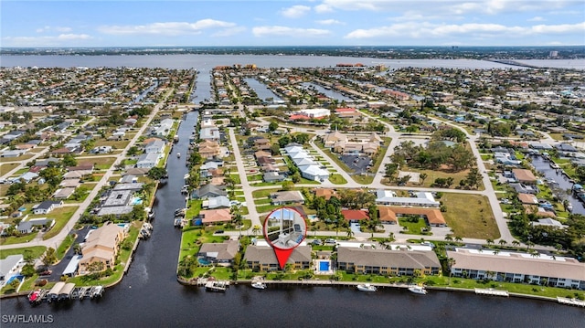 birds eye view of property featuring a water view and a residential view