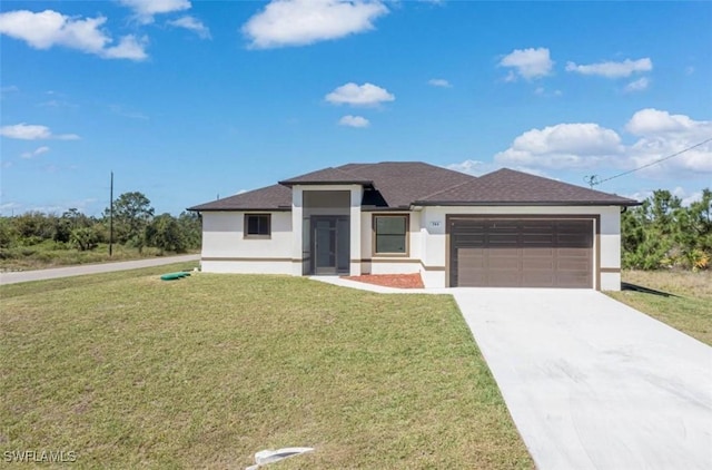 prairie-style home with stucco siding, driveway, a garage, and a front lawn