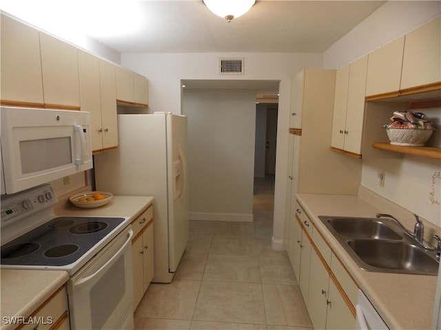 kitchen featuring light countertops, white appliances, visible vents, and a sink