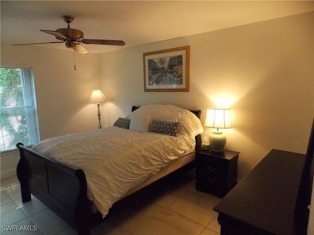 bedroom featuring light tile patterned flooring and ceiling fan