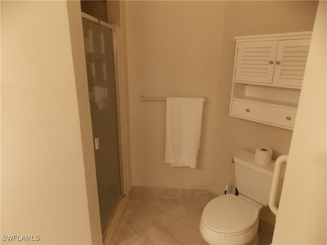 bathroom with toilet, a stall shower, tile patterned flooring, and baseboards