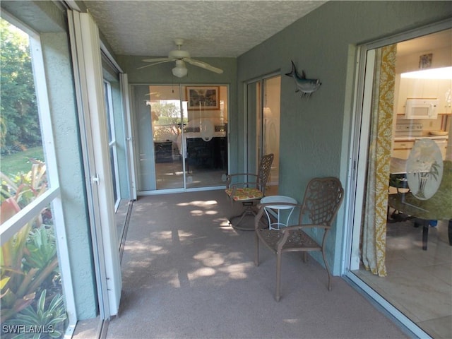 sunroom featuring ceiling fan