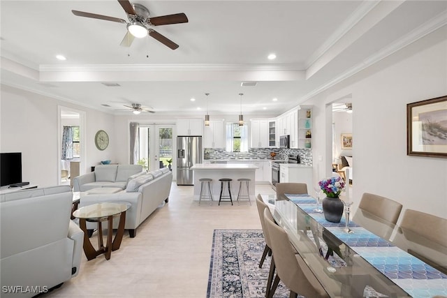 dining space with recessed lighting, a raised ceiling, visible vents, and crown molding