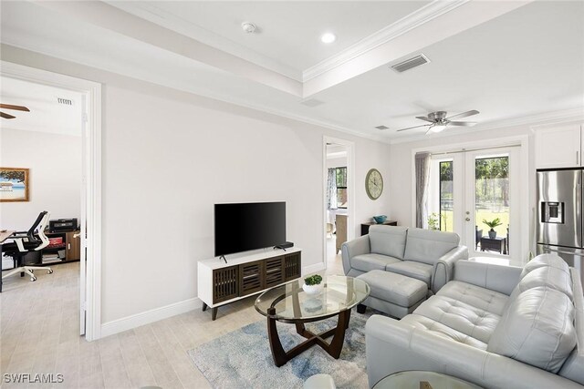 living area featuring ceiling fan, visible vents, ornamental molding, french doors, and light wood-type flooring