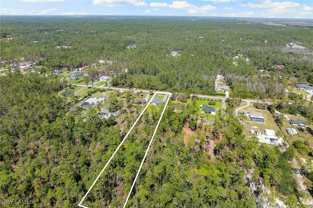 aerial view featuring a wooded view