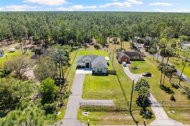 birds eye view of property featuring a view of trees