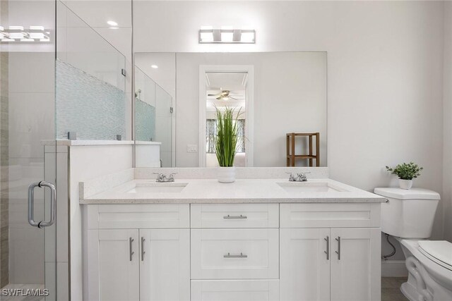 full bath featuring a sink, a shower stall, and toilet